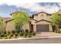 Beautiful home exterior with a paver driveway, two-car garage, and lush landscaping at 12125 Edgehurst Ct, Las Vegas, NV 89138