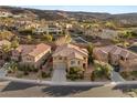 An aerial view showcases this home within a scenic community surrounded by rolling hills and lush greenery at 1265 Vietti St, Henderson, NV 89012