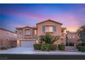 Charming two-story home with a stone facade, well-manicured landscaping, and a two-car garage at 1265 Vietti St, Henderson, NV 89012