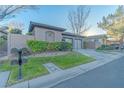 Street view showcasing the home's exterior, landscaping, and curb appeal with mailbox at 17 Chatmoss Rd, Henderson, NV 89052