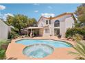 Backyard pool and spa surrounded by mature landscaping and a covered patio area perfect for entertaining at 1707 Navarre Ln, Henderson, NV 89014
