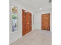 Bright foyer features decorative wood double-doors, tiled flooring, and sidelight windows at 1901 Calle De Espana, Las Vegas, NV 89102
