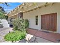 Welcoming front entrance showcasing double wooden doors and a charming courtyard with desert landscaping at 1901 Calle De Espana, Las Vegas, NV 89102