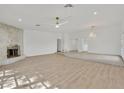 Spacious living room with hardwood flooring, stone fireplace, and neutral decor at 1901 Calle De Espana, Las Vegas, NV 89102