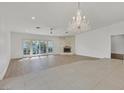 Bright living room with stone fireplace, chandelier, and sliding doors at 1901 Calle De Espana, Las Vegas, NV 89102