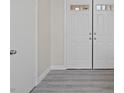 Entryway featuring double doors, wood-look flooring and neutral paint at 1909 Falling Tree Ave, North Las Vegas, NV 89031