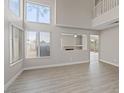 Bright, open living area with high ceilings, large windows, and hardwood floors, perfect for entertaining at 1909 Falling Tree Ave, North Las Vegas, NV 89031