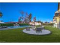 Inviting backyard features a pool, a fire pit, and an outdoor lounge area at 210 E Longacres Dr, Henderson, NV 89015