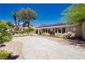 Spacious driveway, manicured landscaping, and large windows add curb appeal to this charming home at 2255 S Buffalo Dr, Las Vegas, NV 89117