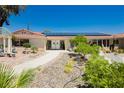 Inviting front yard with well-maintained landscaping, a brick walkway, and double door entry to the home at 2255 S Buffalo Dr, Las Vegas, NV 89117
