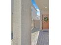 Inviting front entrance with a decorative wreath on the front door and a paver walkway at 2885 Timber Country Rd, North Las Vegas, NV 89086