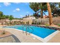 Sparkling pool surrounded by a beautifully tiled deck and mature landscaping for a relaxing outdoor experience at 3920 Autumn St, Las Vegas, NV 89120