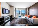 Modern living room with orange accent pillows and city views at 4381 W Flamingo Rd # 1212, Las Vegas, NV 89103