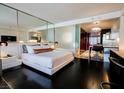 Sleek main bedroom featuring modern decor, dark wood floors, and an adjoining kitchen at 4381 W Flamingo Rd # 1212, Las Vegas, NV 89103