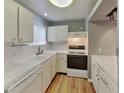 Well-lit kitchen boasting white cabinets, countertops, and appliances at 5043 Spencer St # A, Las Vegas, NV 89119