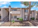 Condo exterior features a neutral color palette, a view of the common areas, and access to upper units at 5241 Janfred Ct # 26, Las Vegas, NV 89103