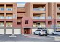 Condominium building exterior displaying unit entrances and covered parking spaces at 59 E Agate Ave # 406, Las Vegas, NV 89123