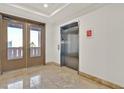 Well lit building lobby with marble tile flooring and elevator access at 59 E Agate Ave # 406, Las Vegas, NV 89123