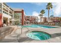 Community pool and spa area with lounge chairs and well-kept grounds at 59 E Agate Ave # 406, Las Vegas, NV 89123