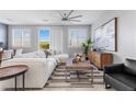 Bright living room with a comfortable sofa, stylish decor, and a ceiling fan at 5918 Peridot Falls Ave, Las Vegas, NV 89130