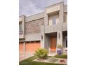 Contemporary home featuring a two-car garage, stone accents, and a welcoming front entrance at 5976 Rockway Glen Ave, Las Vegas, NV 89141