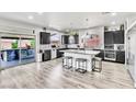 Spacious kitchen with a central island, stainless steel appliances, and access to the backyard patio at 5976 Rockway Glen Ave, Las Vegas, NV 89141
