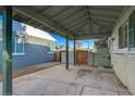 View of a covered carport featuring a concrete floor, supporting columns, and access to side yard at 709 New Mexico St, Boulder City, NV 89005