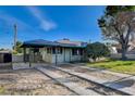 View of house with covered parking, updated landscaping, and hardscaped driveway at 709 New Mexico St, Boulder City, NV 89005