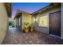 Inviting courtyard with brick pavers and mature potted plants, creating a cozy outdoor space at 712 Webber Park St, Henderson, NV 89011
