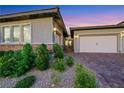 Attractive single-story home featuring a brick-accented facade and lush landscaping at 712 Webber Park St, Henderson, NV 89011