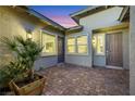 Private outdoor patio featuring brick pavers, desert landscaping and neutral exterior paint at 712 Webber Park St, Henderson, NV 89011