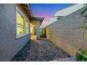 Paver-covered side yard with block wall, providing privacy and outdoor living space at 712 Webber Park St, Henderson, NV 89011