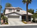 Inviting two-story home featuring a two-car garage and tidy front yard at 7313 Bosky Springs St, Las Vegas, NV 89131