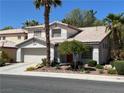 Inviting two-story home featuring a two-car garage and tidy front yard at 7313 Bosky Springs St, Las Vegas, NV 89131