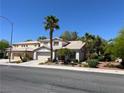 Charming two-story home with a well-manicured lawn and mature palm trees at 7313 Bosky Springs St, Las Vegas, NV 89131