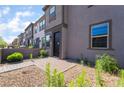 Modern two-story townhouse with neutral exterior, brick accents, and well-maintained landscaping in the front yard at 756 Sleeping City Ave, Henderson, NV 89015