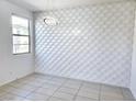 Stylish living room with a decorative wall, modern lighting, and tile flooring at 756 Sleeping City Ave, Henderson, NV 89015