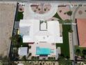 Aerial view of a modern home with lush landscaping, a pool, and a circular driveway at 7575 Coley Ave, Las Vegas, NV 89117