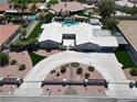 Stunning aerial view of a modern home with lush landscaping, a pool, and a circular driveway at 7575 Coley Ave, Las Vegas, NV 89117