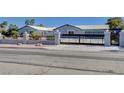 Charming home with a gated entrance, desert landscaping, and a circular driveway at 7575 Coley Ave, Las Vegas, NV 89117