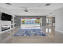Open living room with tile floors, fireplace, and large sliding doors overlooking the pool at 7575 Coley Ave, Las Vegas, NV 89117