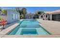 A pristine pool and integrated spa, surrounded by a spacious patio and well-maintained landscaping at 7575 Coley Ave, Las Vegas, NV 89117