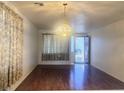 Inviting living room showcasing hardwood floors, natural light, and a decorative chandelier at 7611 Avila Beach Ave, Las Vegas, NV 89113
