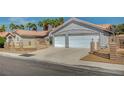 Charming single-story home with a two-car garage, desert landscaping, and a tile roof at 7898 Rye Canyon Dr, Las Vegas, NV 89123