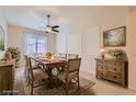 Formal dining room with rustic wooden table, seating for ten, and decorative wall trim and furnishings at 8732 Kendall Brook Cir, Las Vegas, NV 89149