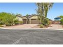 Charming home with a two-car garage, RV parking, and a well-manicured front yard at 8732 Kendall Brook Cir, Las Vegas, NV 89149