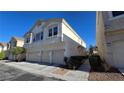 Inviting two-story townhouse with a three-car garage and well-maintained landscaping, perfect for a growing Gathering at 8811 Tomnitz Ave # 101, Las Vegas, NV 89178