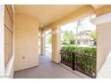 Covered porch with decorative iron railing and view of the landscaped front yard at 901 Sir Winston St, Henderson, NV 89052