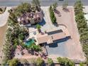 Stunning aerial view of home with a pool, landscaping, and a long driveway at 912 Santa Ynez Ave, Henderson, NV 89002