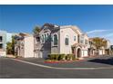 Attractive townhome exterior featuring multi-car garages, neutral stucco, and well-maintained landscaping at 10001 Peace Way # 2228, Las Vegas, NV 89147